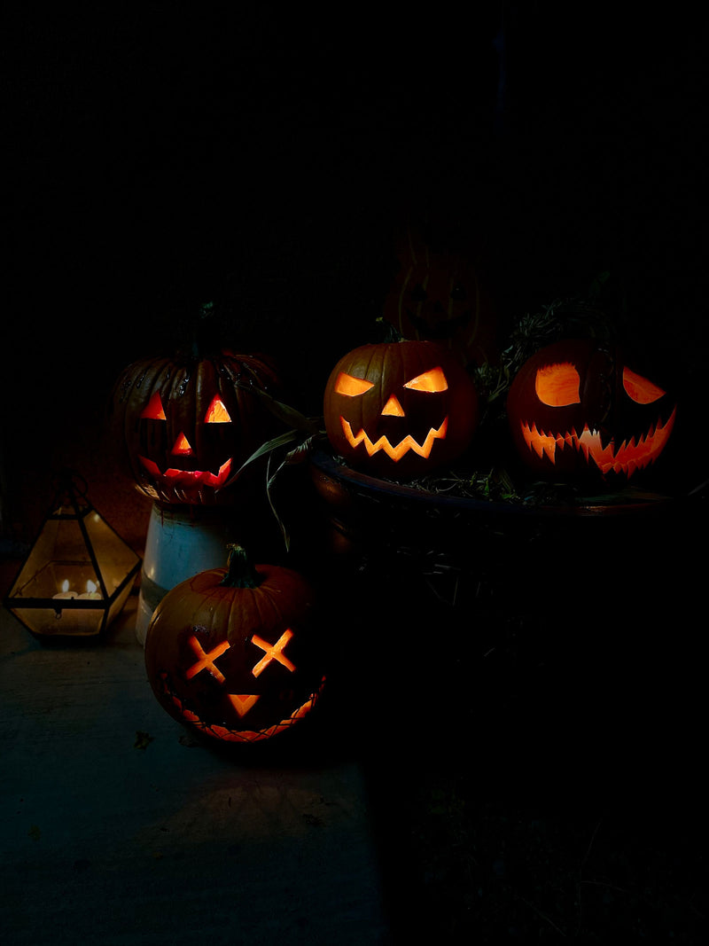 Carved jack-o'-lanterns glowing at night