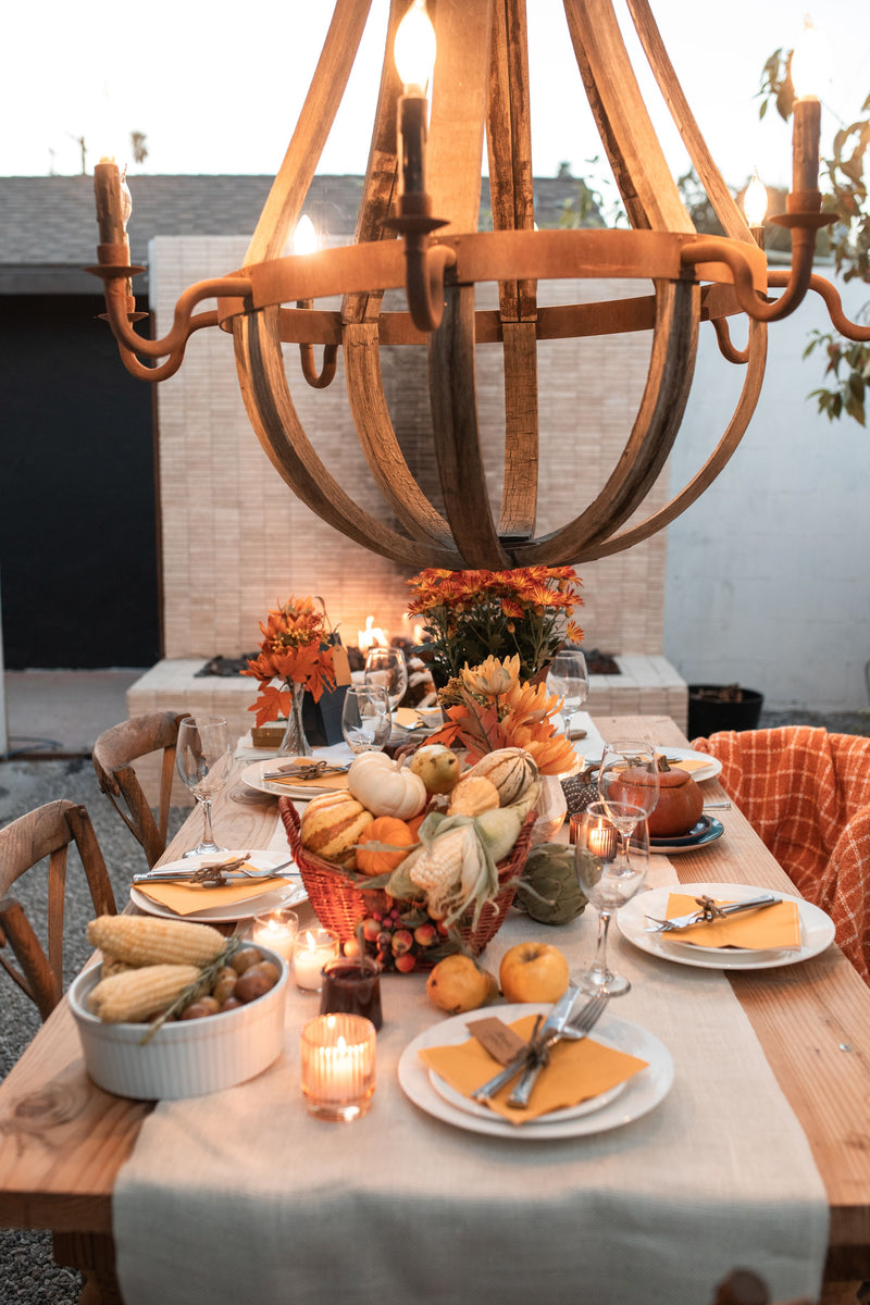Autumn tablescape with pumpkins, candles and place settings