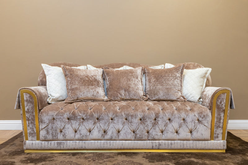 Beige sofa styled with plush decorative pillows